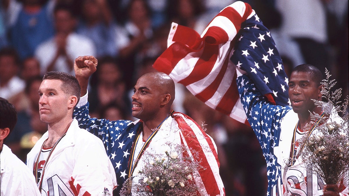 Members of the 1992 U.S. Olympic team hold up the American flag
